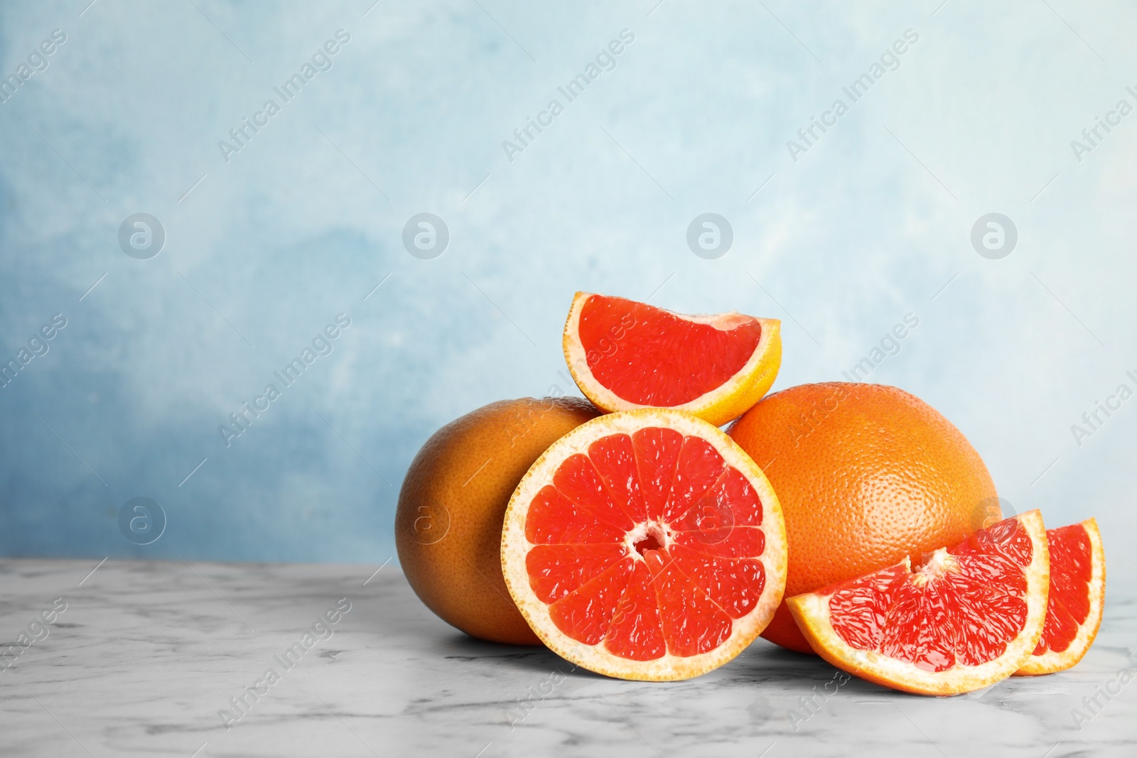 Photo of Fresh tasty grapefruits on table. Space for text