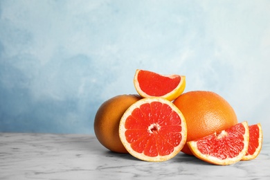 Fresh tasty grapefruits on table. Space for text