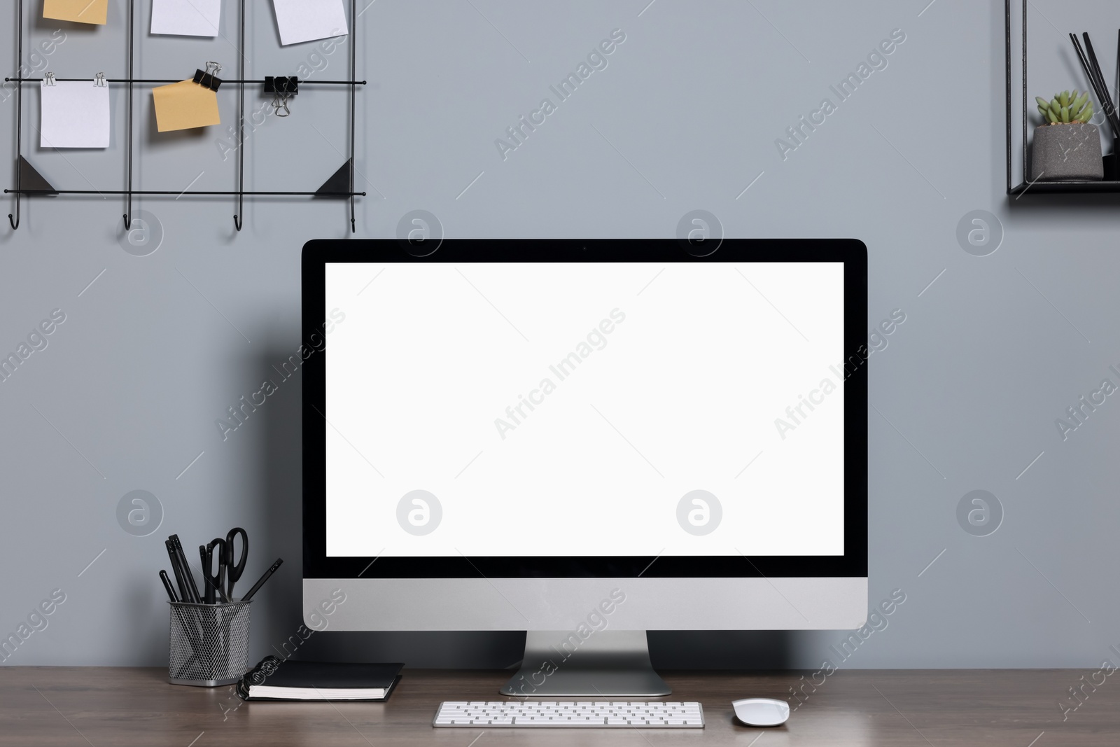 Photo of Cozy workspace with modern computer and stationery on wooden desk