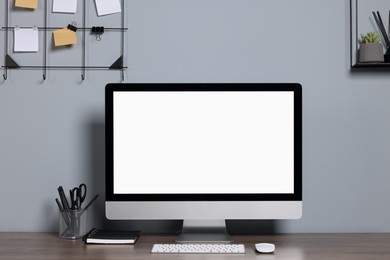 Cozy workspace with modern computer and stationery on wooden desk