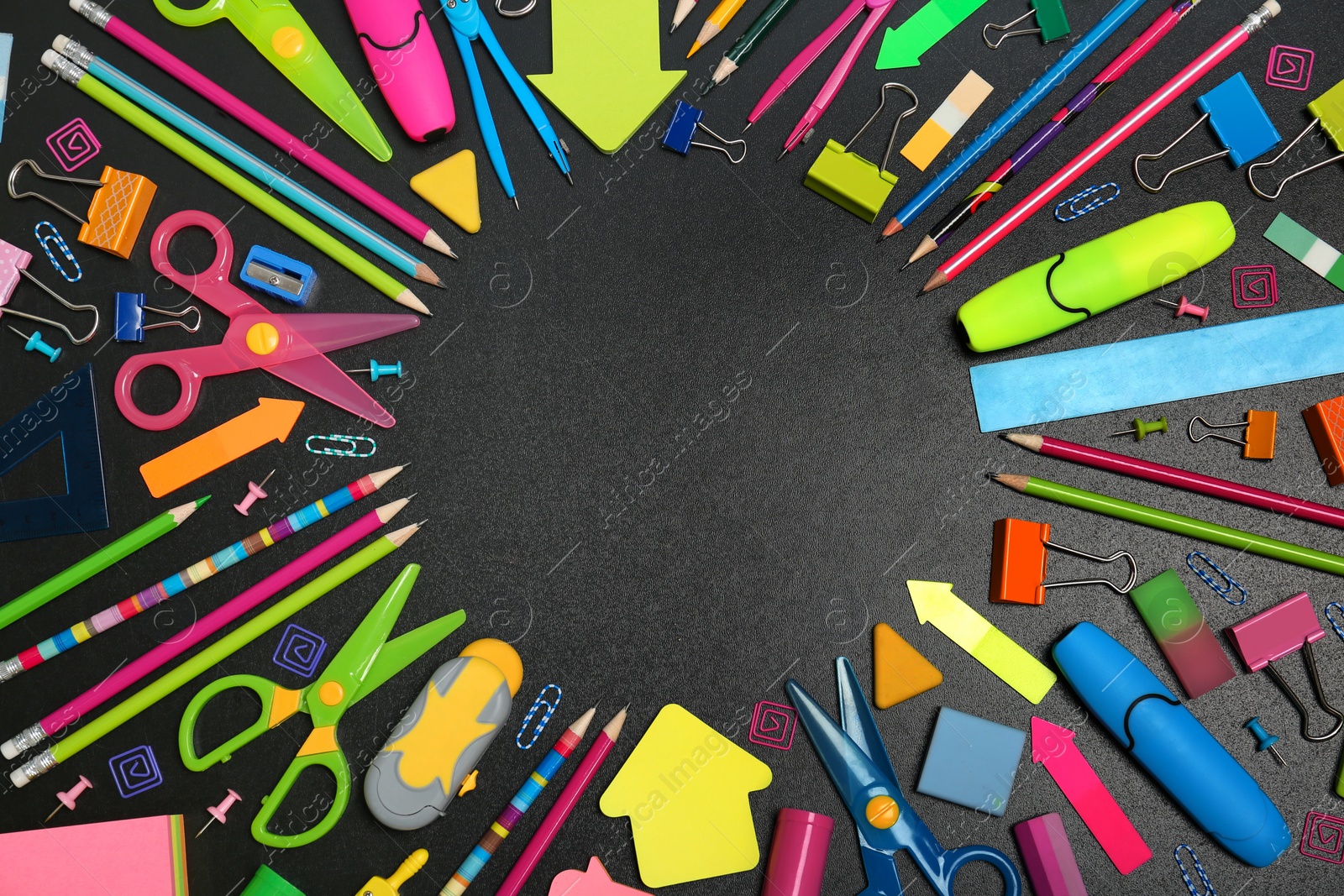 Photo of Flat lay composition with different school stationery on chalkboard surface