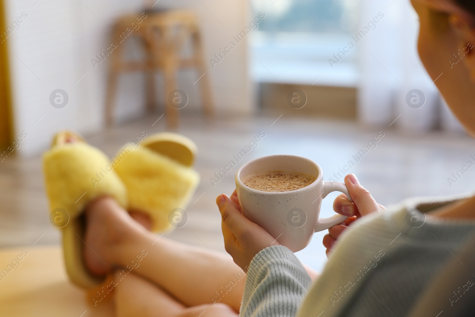 Photo of Woman with cup of aromatic coffee relaxing at home, closeup. Space for text