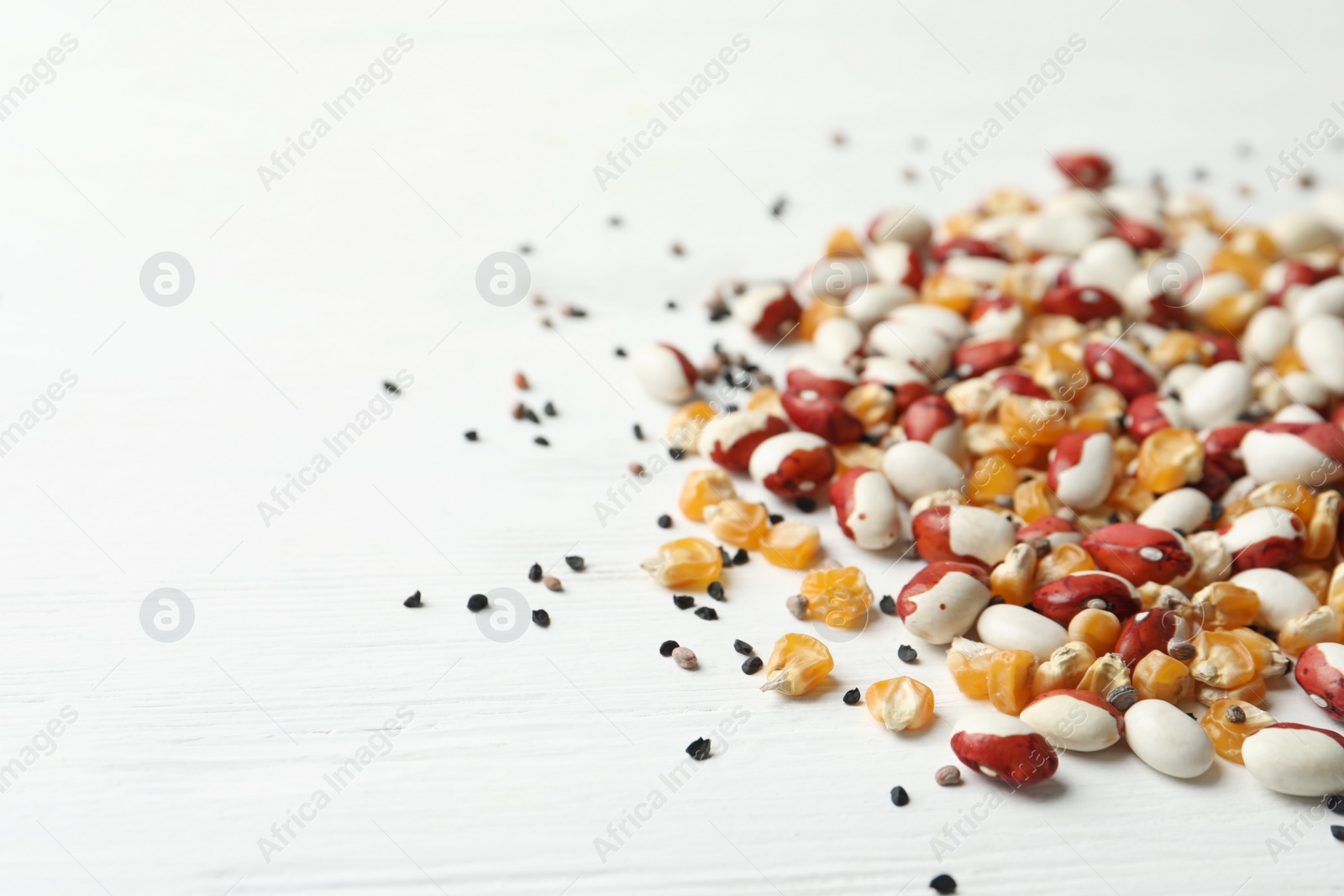 Photo of Mixed vegetable seeds on white wooden background