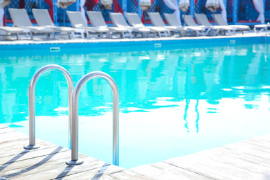 Photo of Ladder with grab bars in outdoor swimming pool