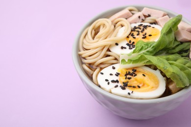 Photo of Bowl of delicious ramen with meat and egg on violet table, closeup with space for text. Noodle soup