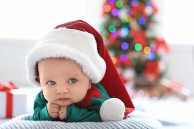 Photo of Cute baby in Christmas costume at home