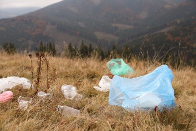 Plastic garbage scattered on grass in nature