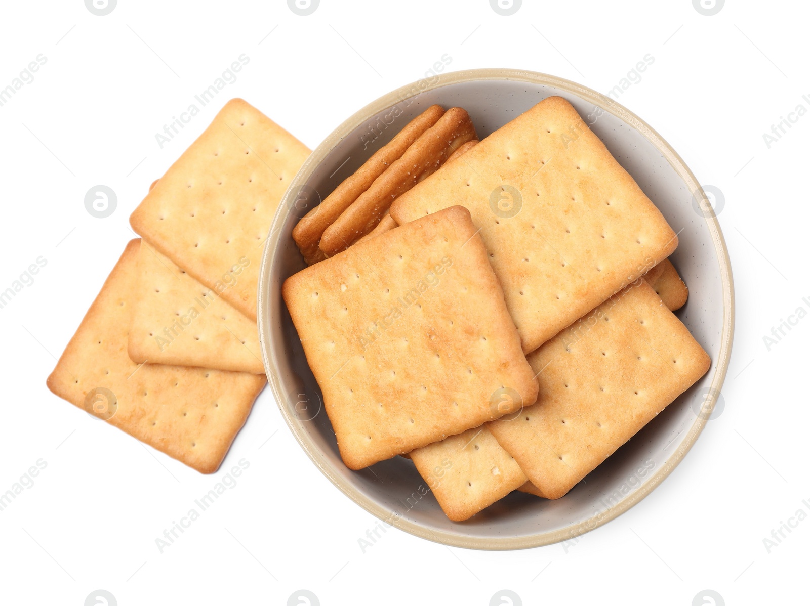 Photo of Tasty crackers in bowl isolated on white, top view