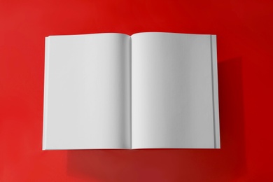 Photo of Empty book pages on red background, top view. Mockup for design