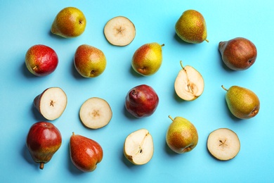 Ripe juicy pears on blue background, flat lay