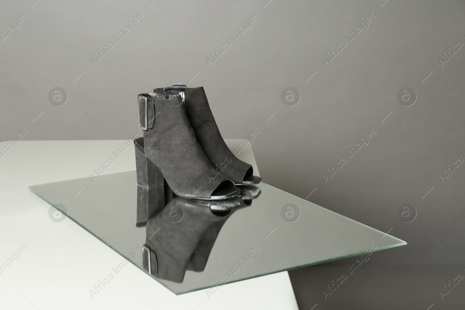 Photo of Pair of lady's shoes on table against grey background, space for text