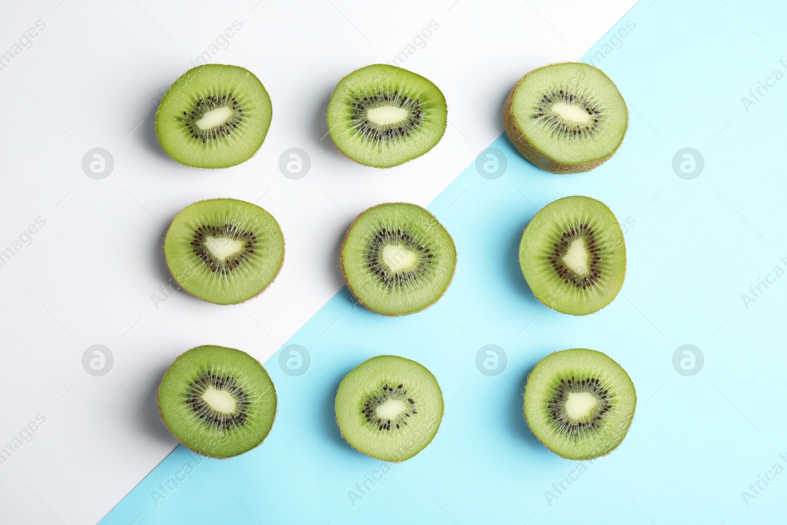 Photo of Top view of sliced fresh kiwis on color background