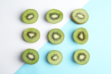 Top view of sliced fresh kiwis on color background