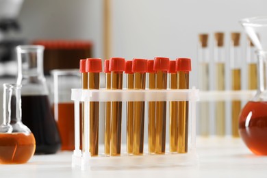 Test tubes with brown liquid on white table