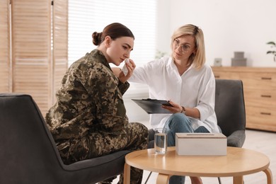 Psychotherapist working with military woman in office