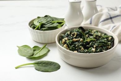 Photo of Tasty spinach dip with eggs in bowl on white table