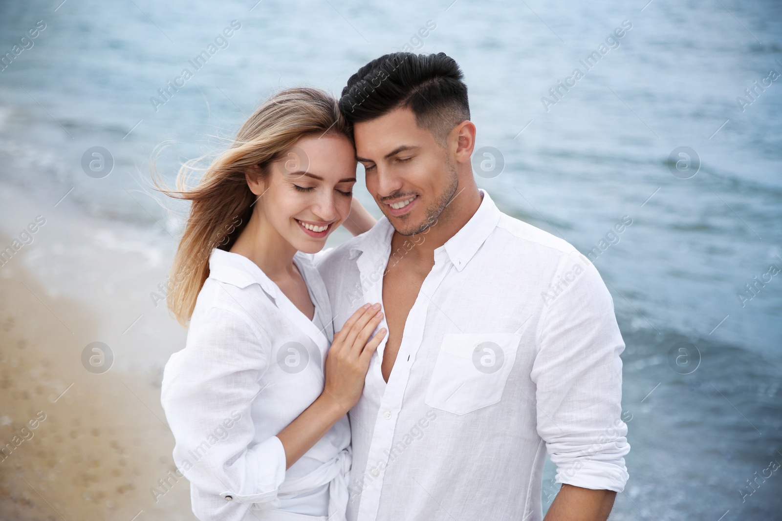 Photo of Happy couple on sea beach. Romantic walk