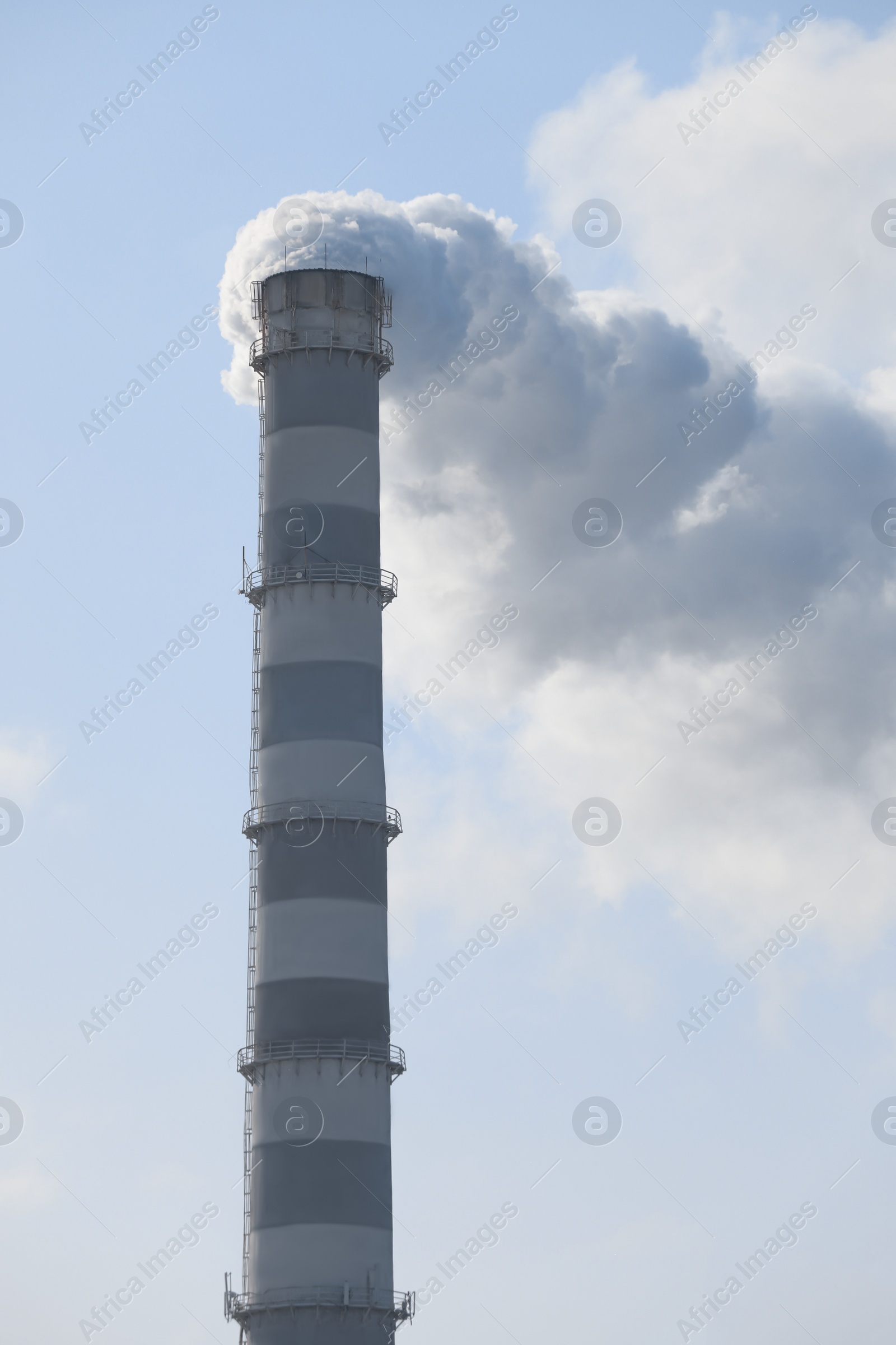 Photo of Polluting air with smoke from industrial chimney outdoors. CO2 emissions