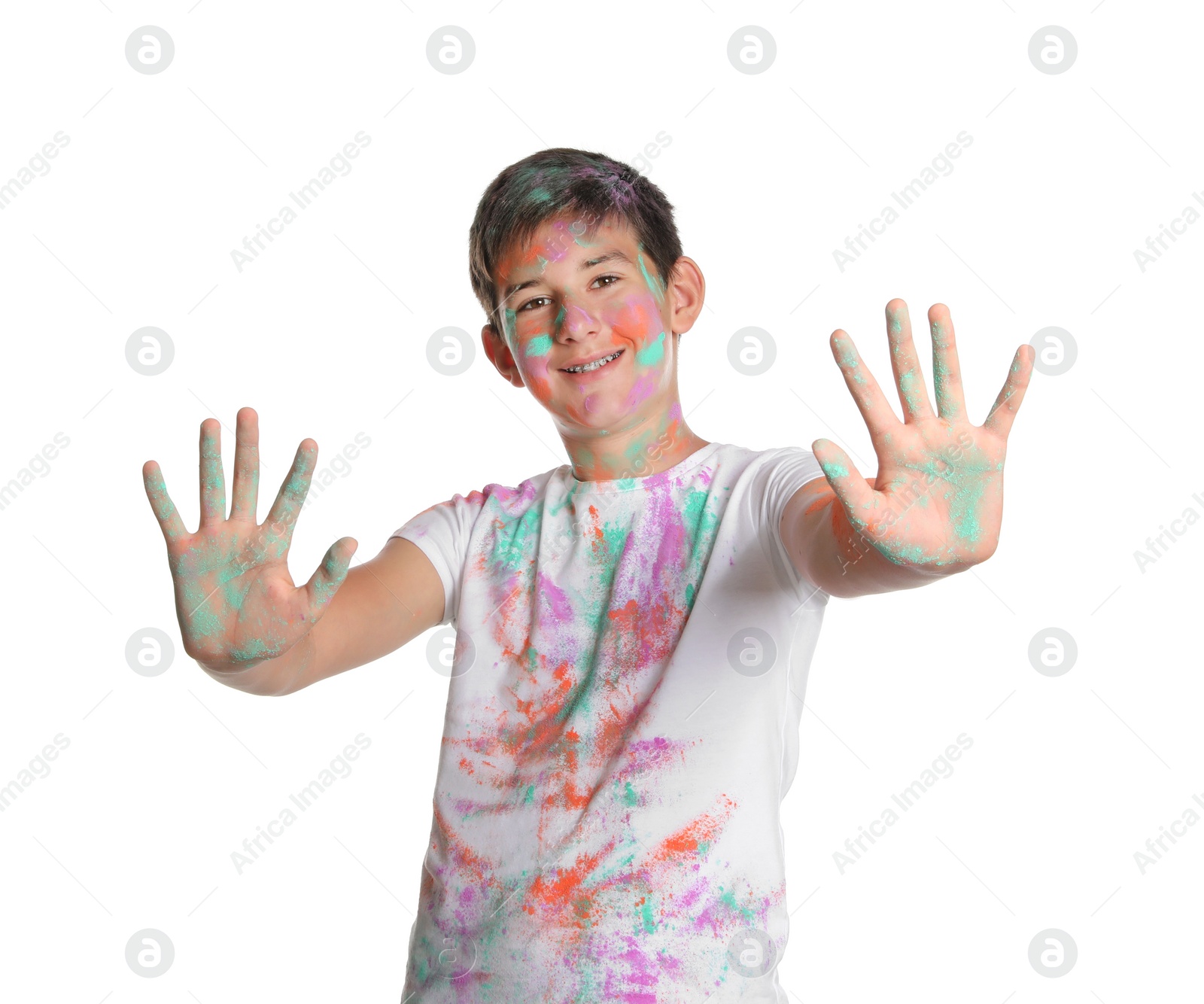 Photo of Teenage boy covered with colorful powder dyes on white background. Holi festival celebration