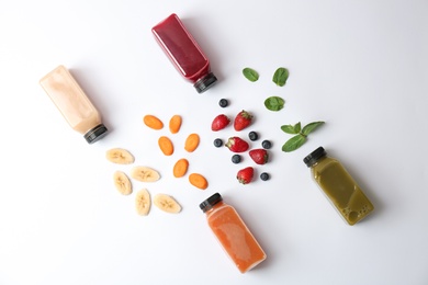 Photo of Flat lay composition with healthy detox smoothies and ingredients on light background