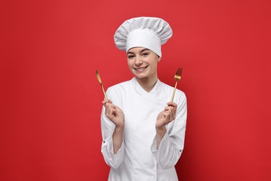 Photo of Professional chef with cutlery on red background
