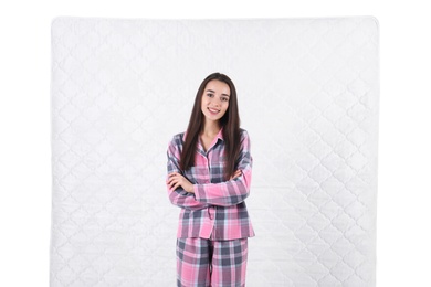 Young woman with comfortable mattress isolated on white