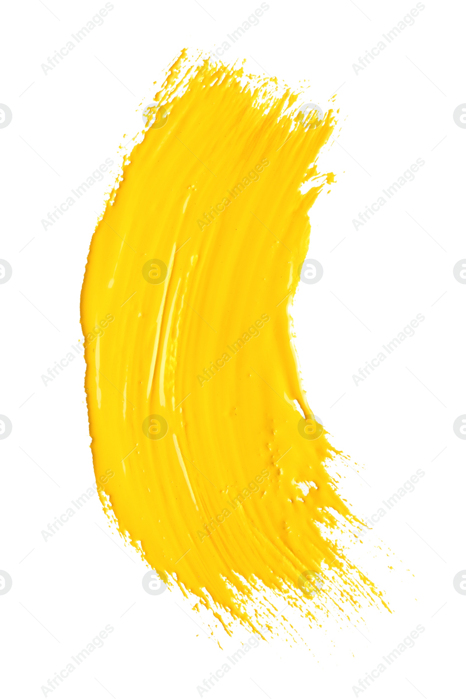 Photo of Abstract brushstroke of yellow paint isolated on white