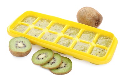 Photo of Kiwi puree in ice cube tray and fresh kiwi fruits isolated on white. Ready for freezing