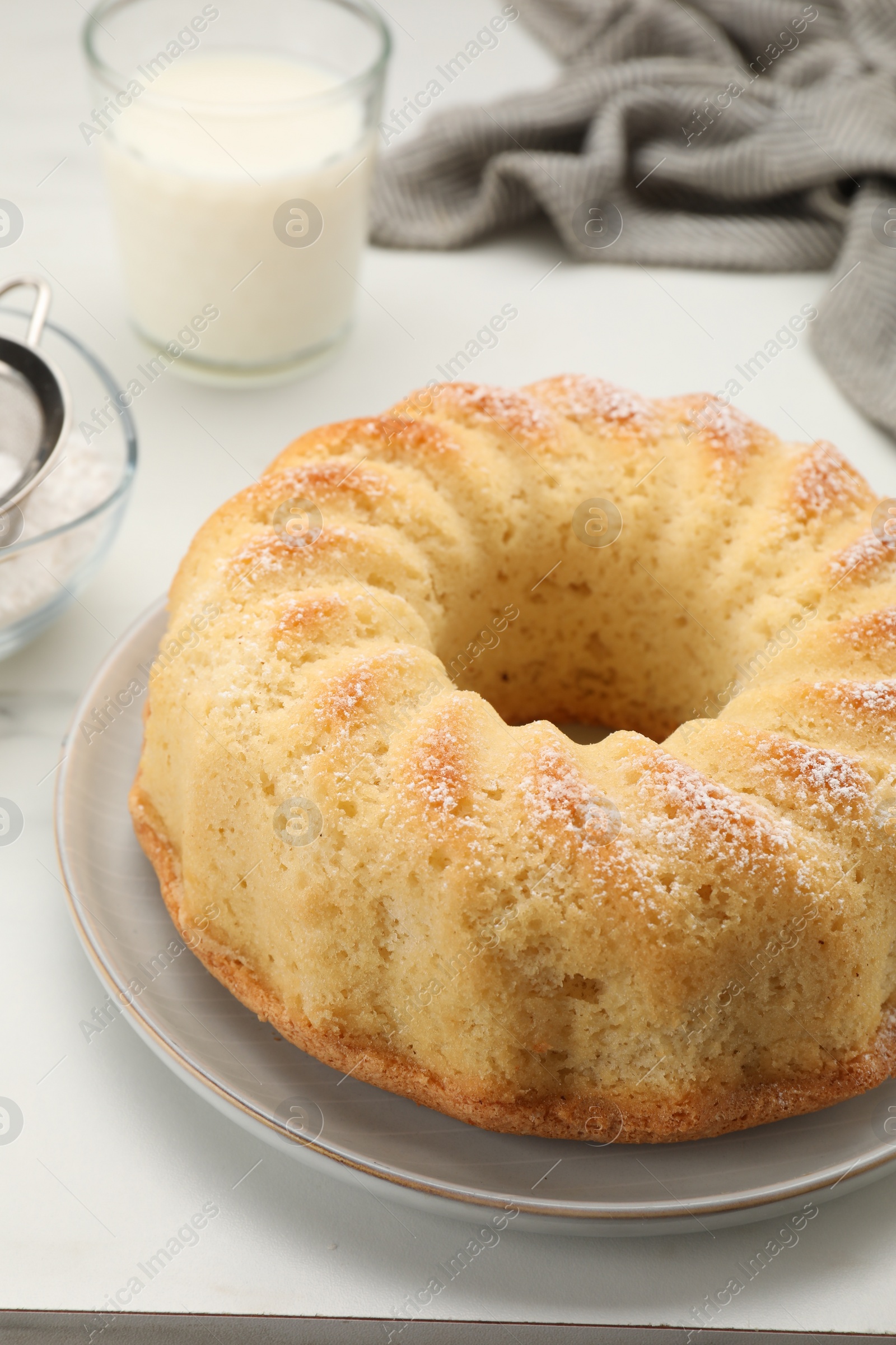 Photo of Delicious freshly baked sponge cake on white table, closeup