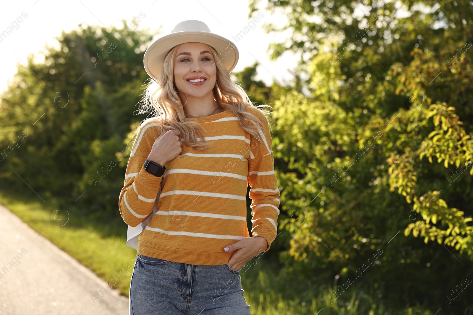 Photo of Portrait of happy young woman in park on spring day