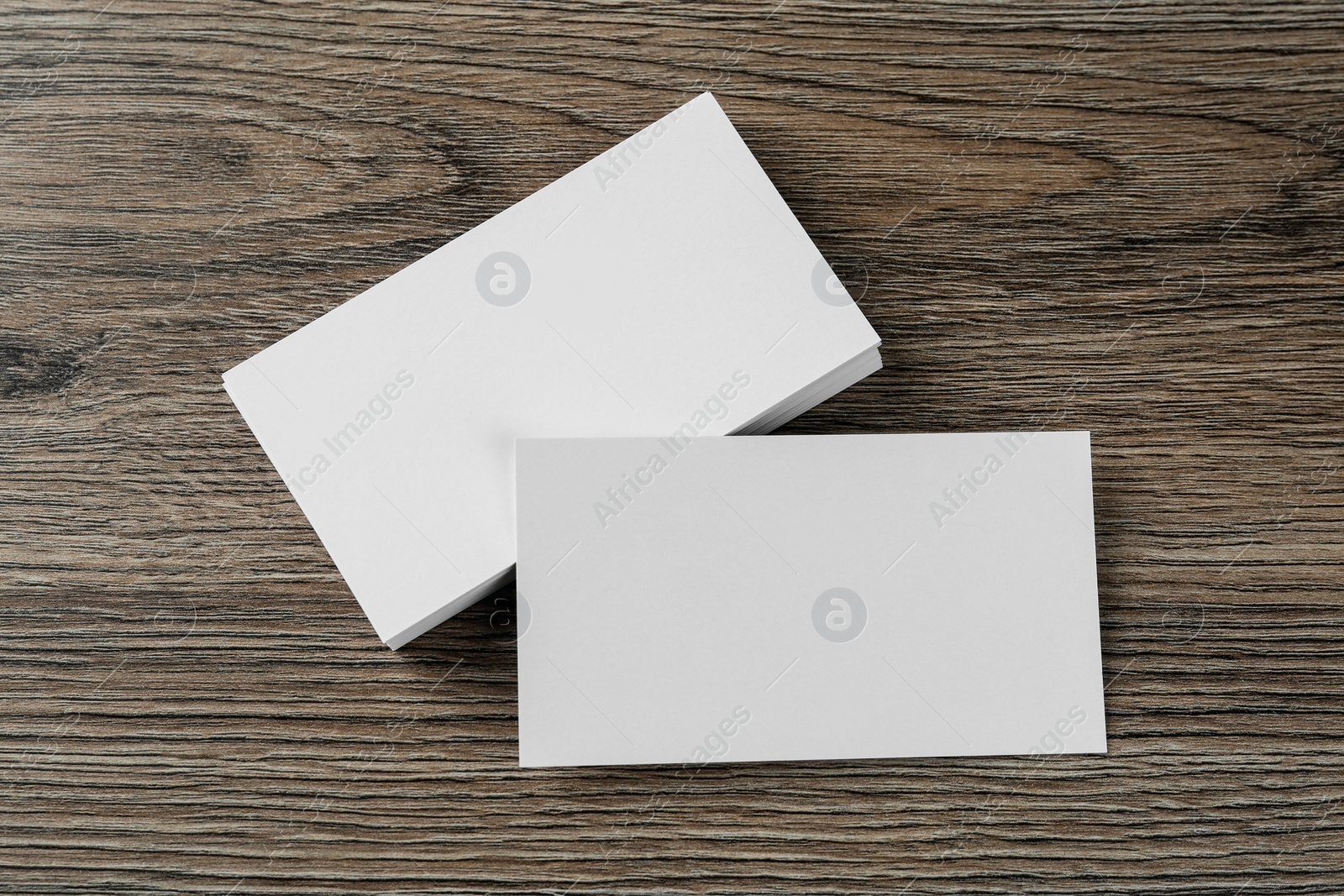 Photo of Blank business cards on wooden background, flat lay. Mockup for design