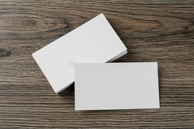 Photo of Blank business cards on wooden background, flat lay. Mockup for design