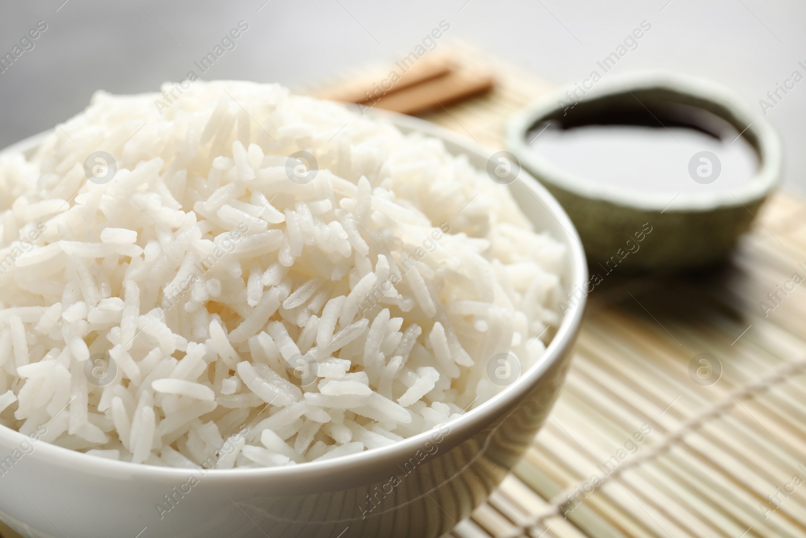 Photo of Bowl of tasty cooked rice served on table, closeup