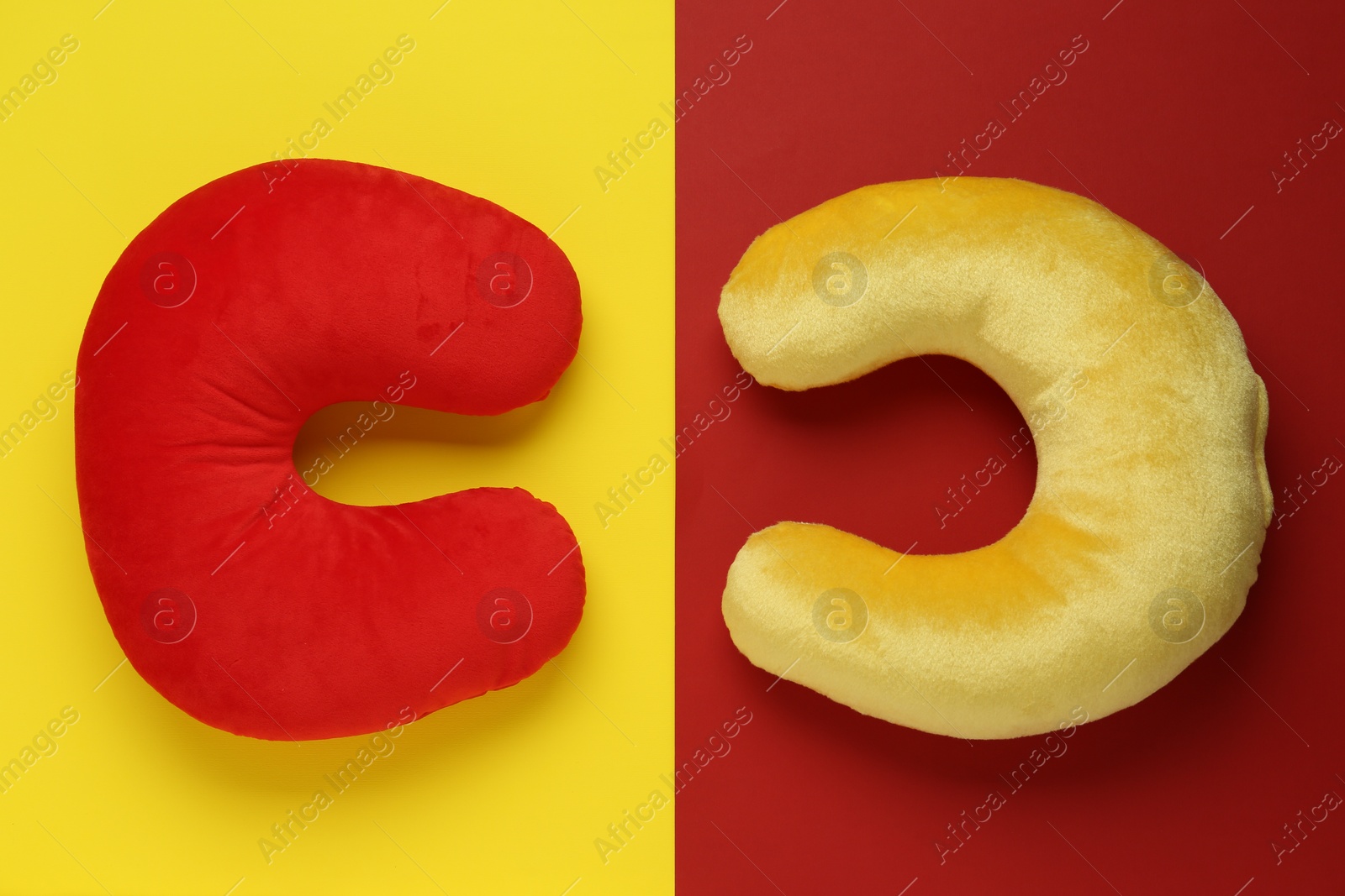 Photo of Travel pillows on color background, flat lay