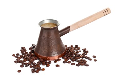 Metal turkish coffee pot with hot drink and beans on white background