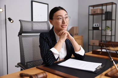 Photo of Portrait of smiling notary at table in office