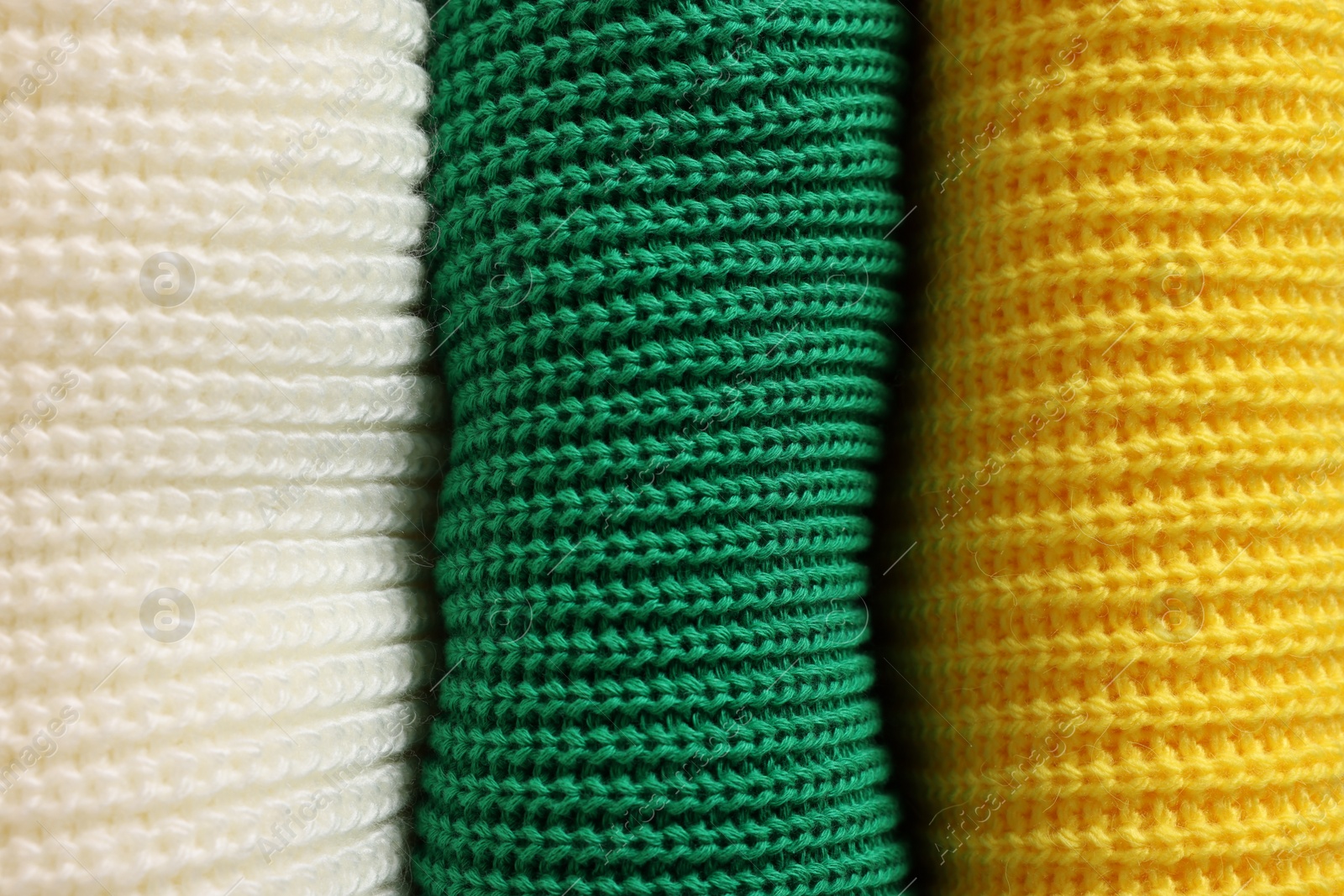 Photo of Closeup view of different warm folded sweaters as background