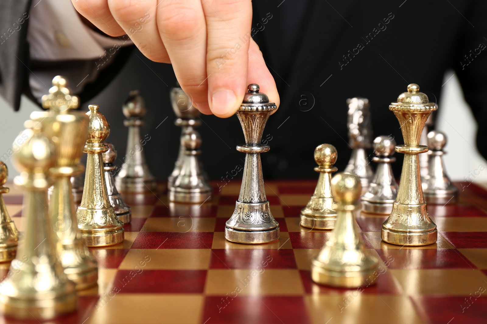 Photo of Man moving chess piece on board, closeup