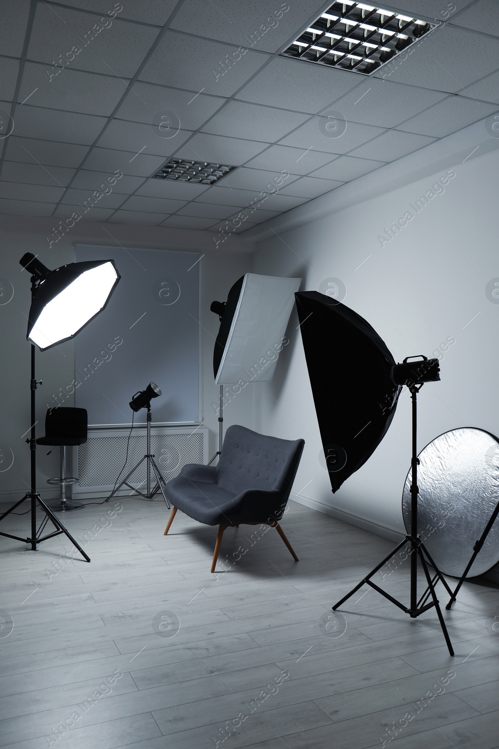 Photo of Modern photo studio with professional lighting equipment