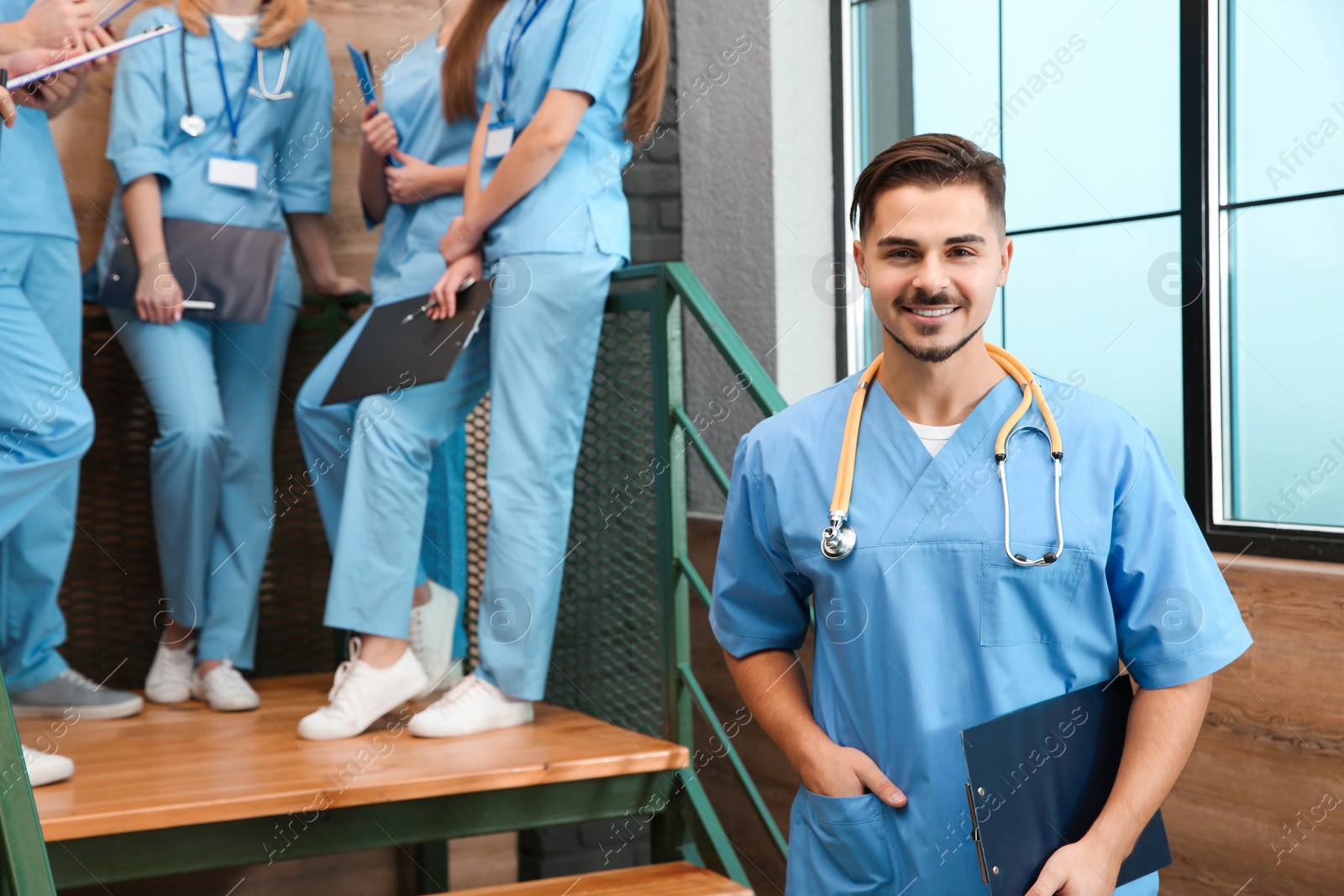 Photo of Medical student with groupmates in university hall