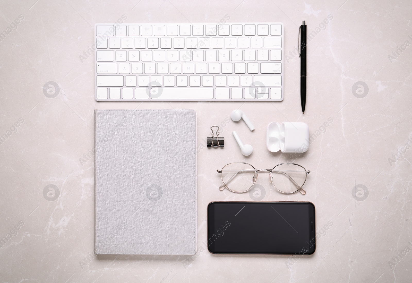 Photo of Flat lay composition with computer keyboard and smartphone on marble background