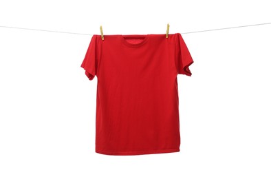 One red t-shirt drying on washing line isolated on white