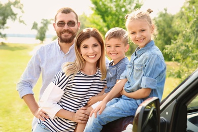 Happy family with children near car outdoors. Taking trip together