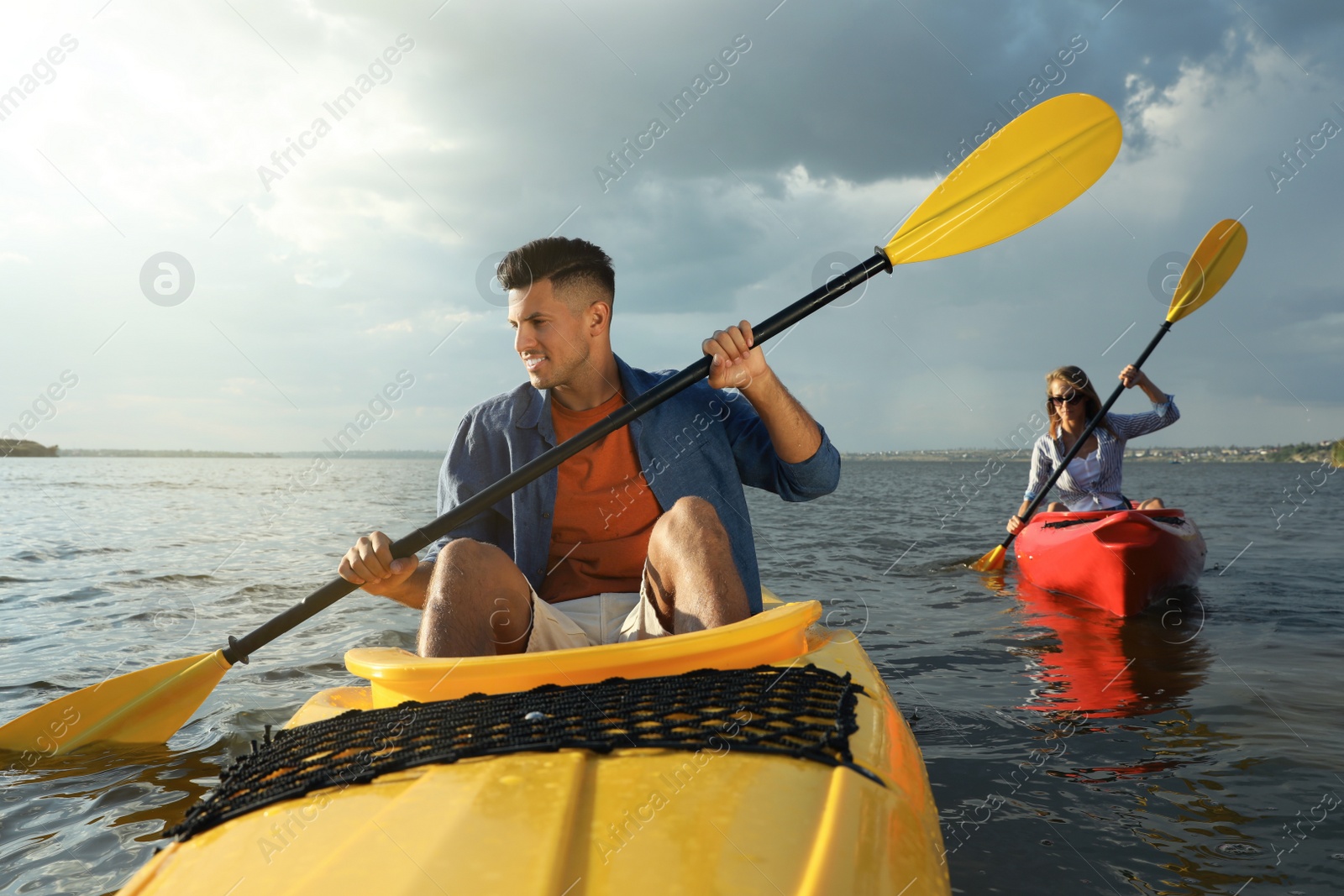 Photo of Beautiful couple kayaking on river. Summer activity