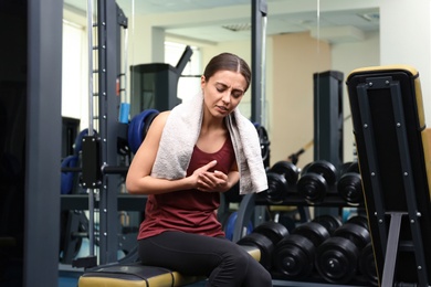 Young woman having heart attack in gym