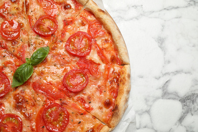 Photo of Delicious pizza Margherita on white marble table, top view