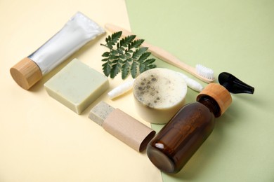 Photo of Eco friendly personal care products and green leaf on color background