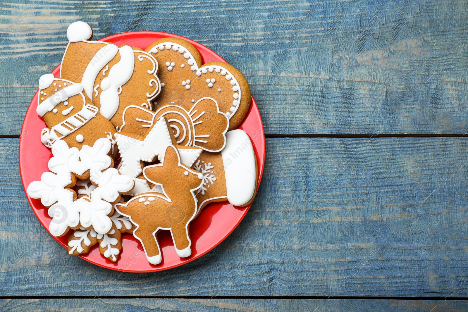 Photo of Delicious Christmas cookies on blue wooden table, top view. Space for text