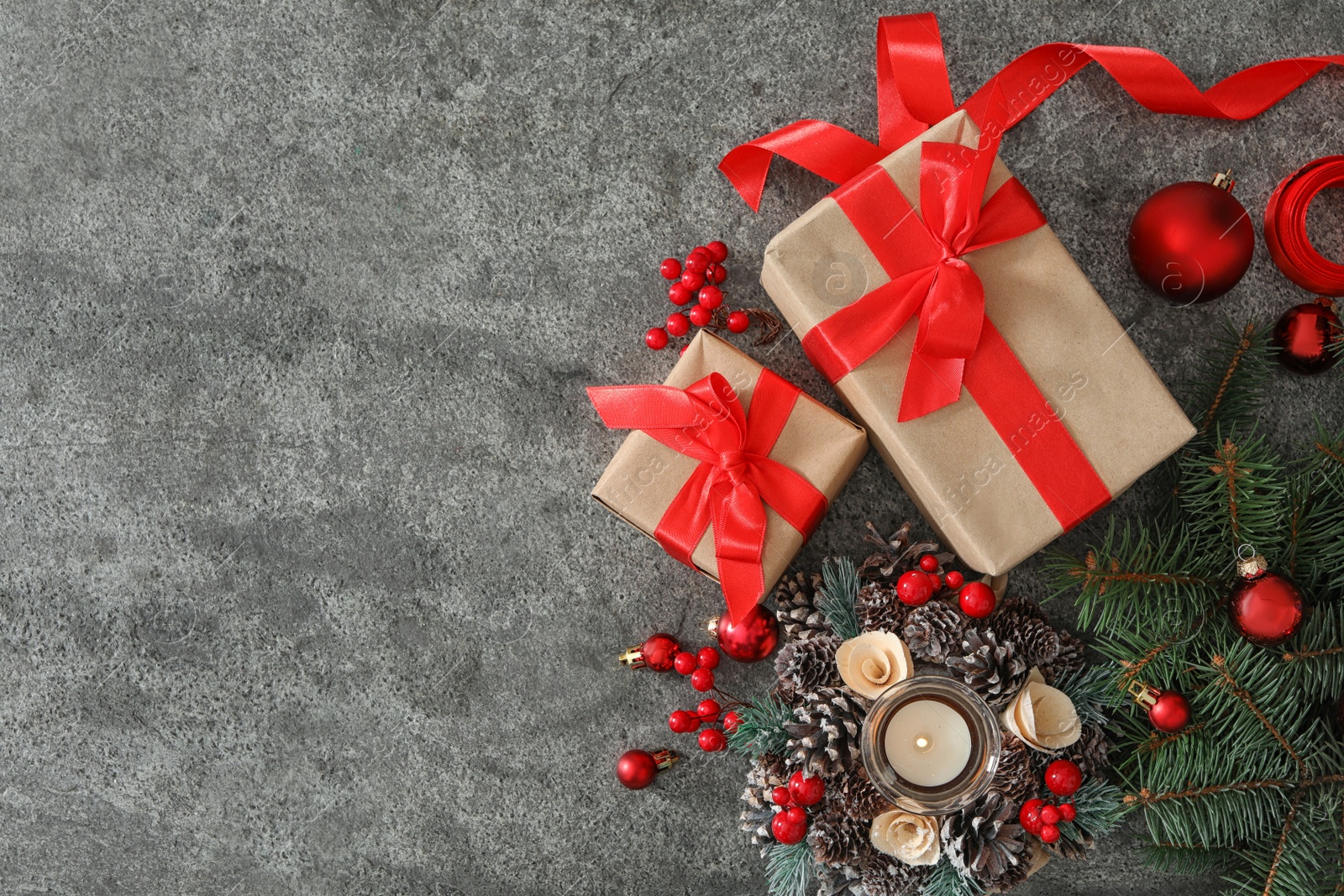 Photo of Flat lay composition with Christmas gift boxes on grey table. Space for text