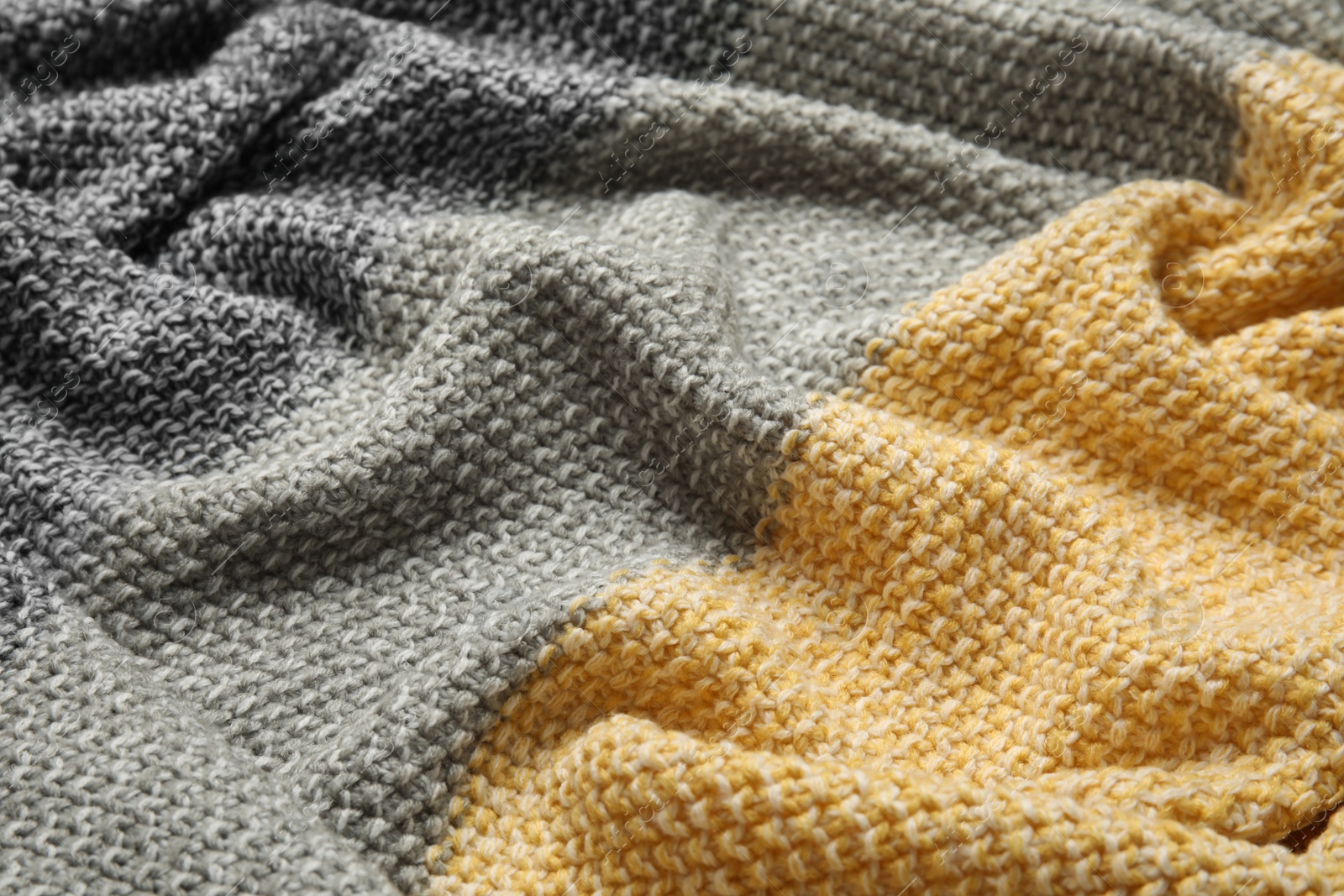 Photo of Soft crumpled knitted plaid as background, closeup